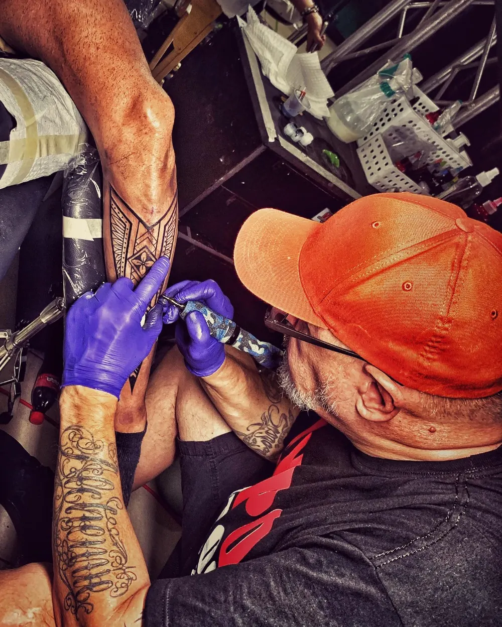 Xelo tattooing with gloved hands